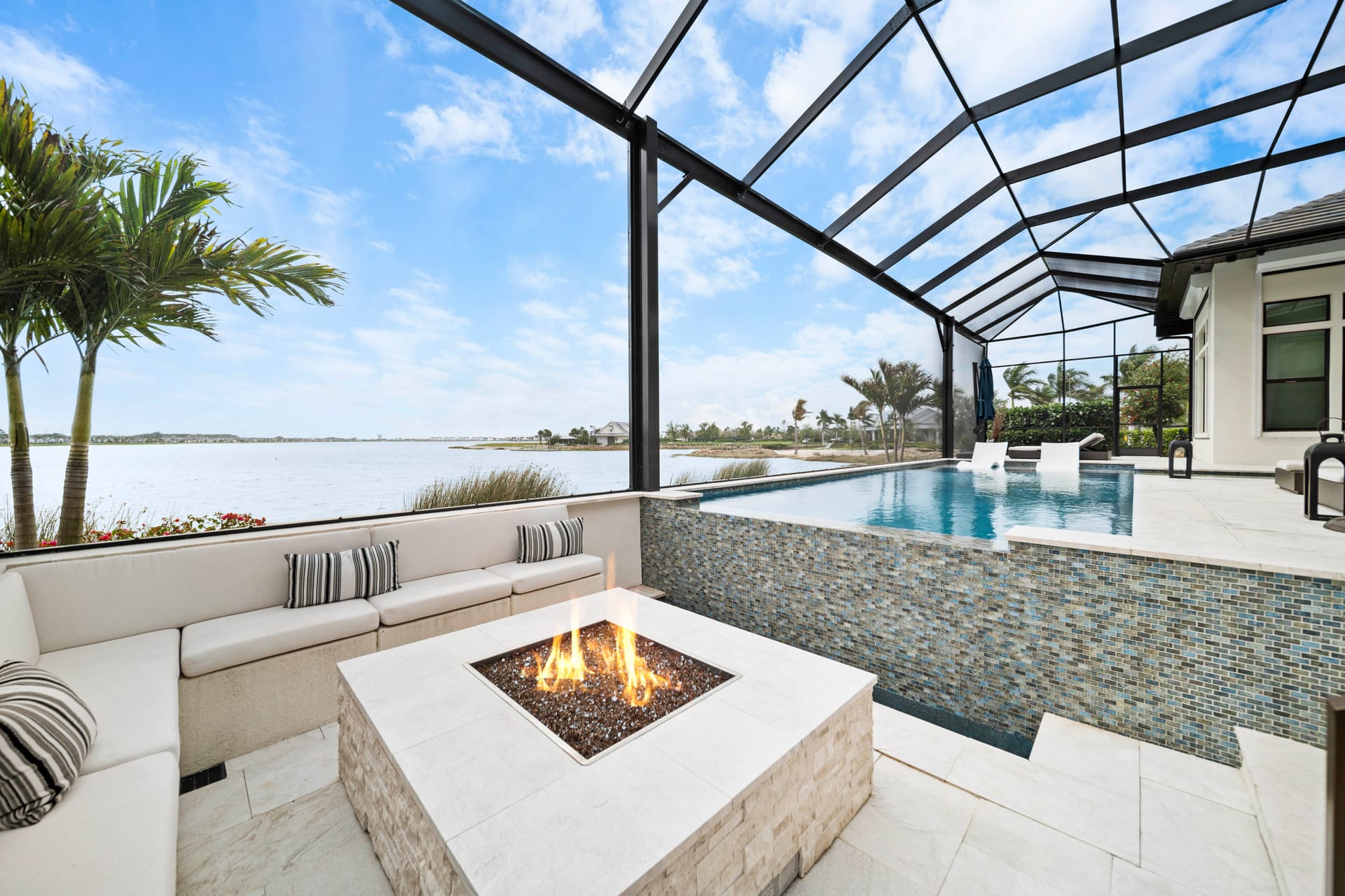Sunken fire pit and seating area beside the vanishing edge pool at dusk, Lakewood Ranch FL, Swim Inc.