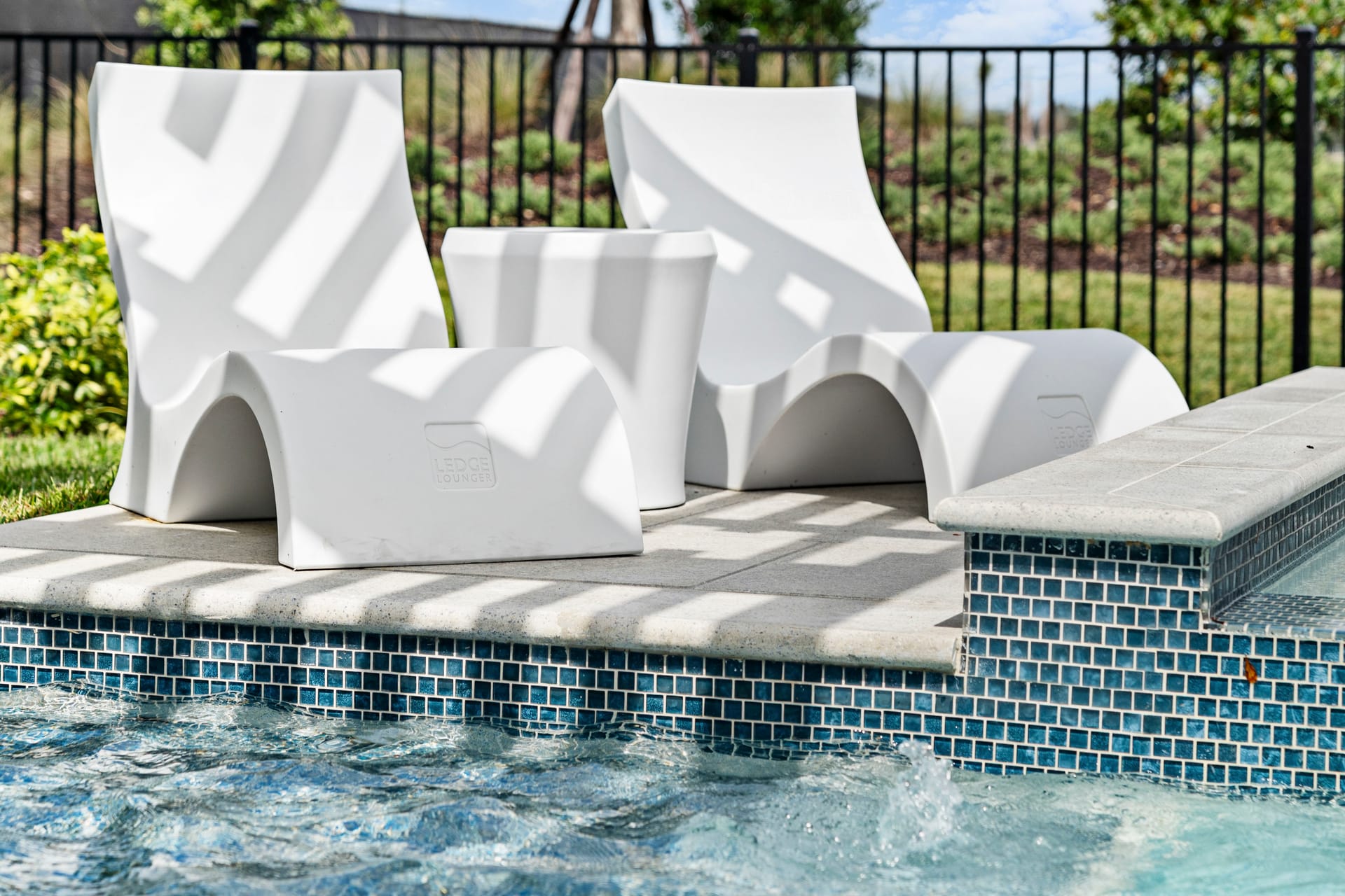 Raised sun shelf with shallow water and bubbler on geometric pool, Venice FL