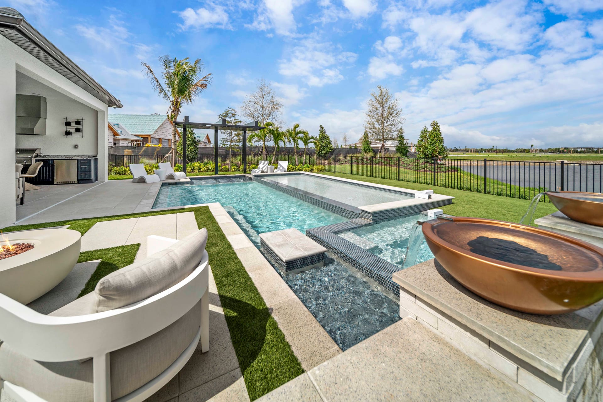 Dramatic pool remodel result, upgraded features, new deck, and transformed backyard showing full-scope renovation by Swim Inc. Sarasota